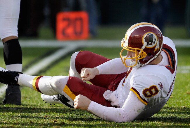 PHILADELPHIA, PA - JANUARY 01: Quarterback Rex Grossman #8 of the Washington Redskins gets up after being hit against the Philadelphia Eagles at Lincoln Financial Field on January 1, 2012 in Philadelphia, Pennsylvania.  (Photo by Rob Carr/Getty Images)