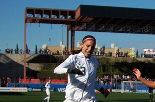 FRISCO, TX - FEBRUARY 11:  Alex Morgan #13 of USA dribbles the ball past Ali Riley #7 of New Zealand during an international friendly at FC Dallas Stadium on February 11, 2012 in Frisco, Texas.  (Photo by Ronald Martinez/Getty Images)