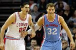 CHARLOTTE, NC - FEBRUARY 11:  Blake Griffin #32 of the Los Angeles Clippers smiles after a dunk as Byron Mullens #22 of the Charlotte Bobcats watches on during their game at Time Warner Cable Arena on February 11, 2012 in Charlotte, North Carolina. NOTE TO USER: User expressly acknowledges and agrees that, by downloading and or using this photograph, User is consenting to the terms and conditions of the Getty Images License Agreement.  (Photo by Streeter Lecka/Getty Images)