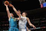 DENVER, CO - JANUARY 09:  Chris Kaman #35 of the New Orleans Hornets tries to get off a shot against Timofey Mozgov #25 of the Denver Nuggets at the Pepsi Center on January 9, 2012 in Denver, Colorado. NOTE TO USER: User expressly acknowledges and agrees that, by downloading and or using this photograph, User is consenting to the terms and conditions of the Getty Images License Agreement.  (Photo by Doug Pensinger/Getty Images)