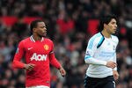 MANCHESTER, ENGLAND - FEBRUARY 11:  Patrice Evra of Manchester United jogs with Luis Suarez of Liverpool during the Barclays Premier League match between Manchester United and Liverpool at Old Trafford on February 11, 2012 in Manchester, England.  (Photo by Shaun Botterill/Getty Images)