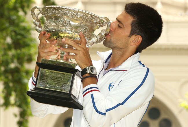 MELBOURNE, AUSTRALIA - JANUARY 30:  Novak Djokovic of Serbia poses with the Norman Brookes Challenge Cup after winning the 2012 men's Australian Open, at Carlton Gardens on January 30, 2012 in Melbourne, Australia.  (Photo by Lucas Dawson/Getty Images)