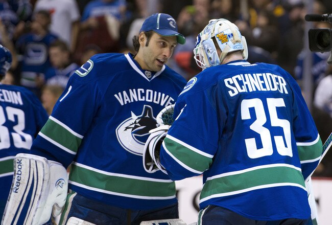 VANCOUVER, CANADA - NOVEMBER 29: Goalie Roberto Luongo #1 of the Vancouver Canucks congratulates goalie Cory Schneider #35 after defeating the Columbus Blue Jackets in NHL action on November 29, 2011 at Rogers Arena in Vancouver, British Columbia, Canada.  (Photo by Rich Lam/Getty Images)