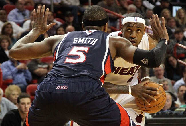 MIAMI, FL - JANUARY 18:  LeBron James #6 of the Miami Heat is guarded by Josh Smith #5 of the Atlanta Hawks during a game at American Airlines Arena on January 18, 2011 in Miami, Florida. NOTE TO USER: User expressly acknowledges and agrees that, by downloading and/or using this Photograph, User is consenting to the terms and conditions of the Getty Images License Agreement.  (Photo by Mike Ehrmann/Getty Images)