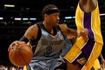 LOS ANGELES - NOVEMBER 6: Allen Iverson #3 of the Memphis Grizzlies drives against Josh Powell #21 of the Los Angeles Lakers on November 6, 2009 at Staples Center in Los Angeles, California. The Lakers won 114-98.  NOTE TO USER: User expressly acknowledges and agrees that, by downloading and/or using this Photograph, user is consenting to the terms and conditions of the Getty Images License Agreement. (Photo by Stephen Dunn/Getty Images)