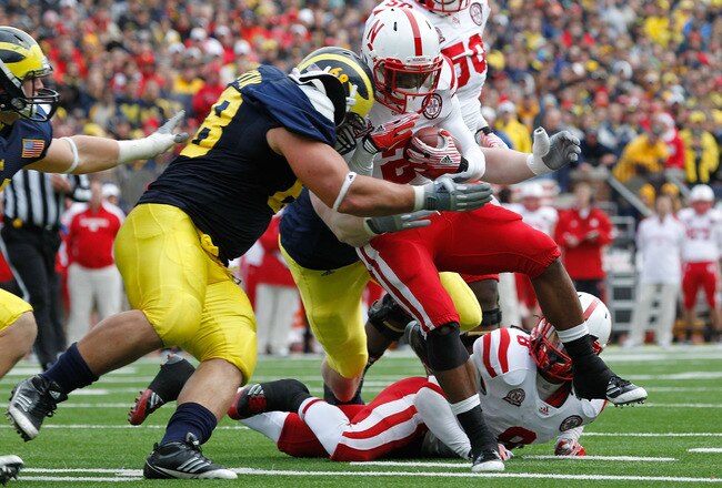 ANN ARBOR, MI - NOVEMBER 19: Ameer Abdullah #8 of the Nebraska Cornhuskers takes a hit from Mike Martin #68 of the Michigan Wolverines during a third quarter run at Michigan Stadium on November 19, 2011 in Ann Arbor, Michigan. Michigan won the game 45-17. (Photo by Gregory Shamus/Getty Images)