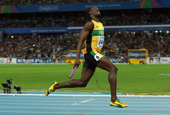DAEGU, SOUTH KOREA - SEPTEMBER 04:  Usain Bolt of Jamaica sprints to victory and a new world record in the men's 4x100 metres relay final during day nine of 13th IAAF World Athletics Championships at Daegu Stadium on September 4, 2011 in Daegu, South Korea.  (Photo by Mark Dadswell/Getty Images)