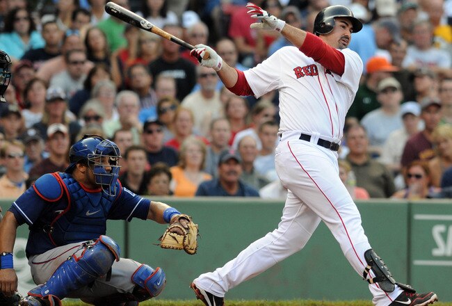 BOSTON, MA - SEPTEMBER 03: Adrian Gonzalez #28 of the Boston Red Sox swings at a pitch as catcher Yorvid Torrealba #8 of the Texas Rangers looks on in the third inning at Fenway Park on September 3, 2011 in Boston, Massachusetts. The Boston Red Sox won the game 12-7. (Photo by Darren McCollester/Getty Images)