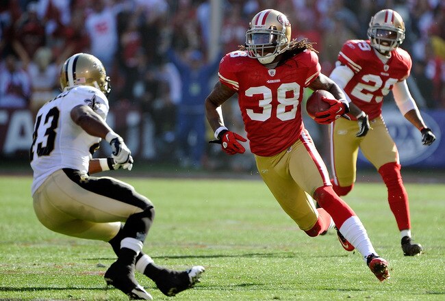 SAN FRANCISCO, CA - JANUARY 14: Dashon Goldson #38 of the San Francisco 49ers returns an interception looking to put a move on Darren Sproles #43 of the New Orleans Saints during the Divisional Playoffs at Candlestick Park on January 14, 2012 in San Francisco, California.  (Photo by Thearon W. Henderson/Getty Images)