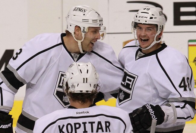 DALLAS, TX - FEBRUARY 12:  Andrei Loktionov #48 of the Los Angeles Kings celebrates a goal with Jack Johnson #3 and Anze Kopitar #11 during play against the Dallas Stars at American Airlines Center on February 12, 2012 in Dallas, Texas.  (Photo by Ronald Martinez/Getty Images)