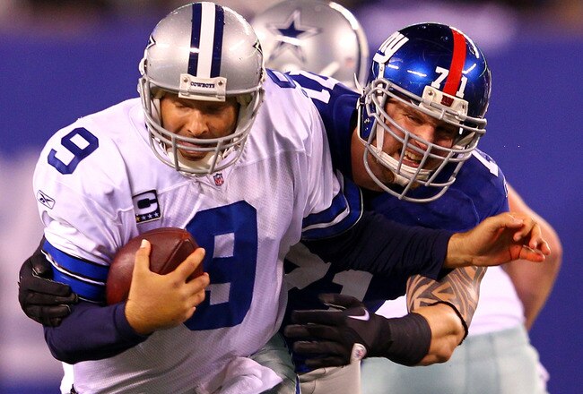 EAST RUTHERFORD, NJ - JANUARY 01:   Dave Tollefson #71 of the New York Giants tries to tackle  Tony Romo #9 of the Dallas Cowboys at MetLife Stadium on January 1, 2012 in East Rutherford, New Jersey.  (Photo by Al Bello/Getty Images)