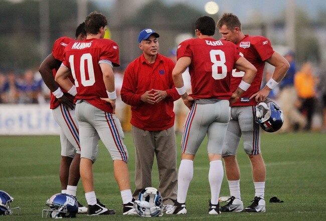 EAST RUTHERFORD, NJ - AUGUST 08:  Quarterback coach Mike Sullivan of the New York Giants speaks Eli Manning #10, David Carr #8, Ryan Perrilloux #5, and Sage Rosenfels #18 take part in practice at New Meadowlands Sports Complex on August 8, 2011 in East Rutherford, New Jersey.  (Photo by Patrick McDermott/Getty Images)