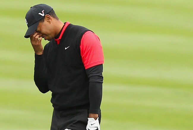 PEBBLE BEACH, CA - FEBRUARY 12:  Tiger Woods reacts after hitting his second shot on the 14th hole during the final round of the AT&T Pebble Beach National Pro-Am at Pebble Beach Golf Links on February 12, 2012 in Pebble Beach, California.  (Photo by Ezra Shaw/Getty Images)