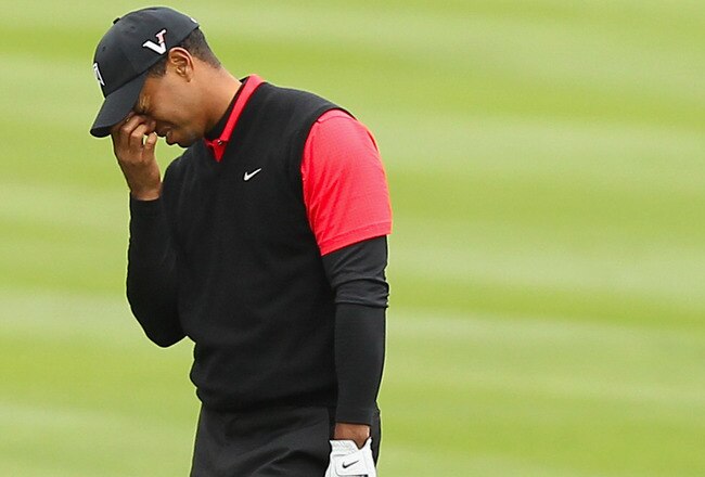 PEBBLE BEACH, CA - FEBRUARY 12:  Tiger Woods reacts after hitting his second shot on the 14th hole during the final round of the AT&T Pebble Beach National Pro-Am at Pebble Beach Golf Links on February 12, 2012 in Pebble Beach, California.  (Photo by Ezra Shaw/Getty Images)