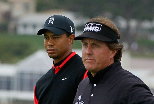 PEBBLE BEACH, CA - FEBRUARY 12: (L-R) Tiger Woods and Phil Mickelson wait on the seventh hole tee during the final round of the AT&T Pebble Beach National Pro-Am at Pebble Beach Golf Links on February 12, 2012 in Pebble Beach, California.  (Photo by Jeff Gross/Getty Images)
