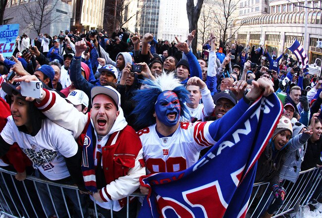 NEW YORK, NY - FEBRUARY 07:  New York Giants fans cheer during the New York Giants ticker tape victory parade down the Canyon of Heros on February 7, 2012 in New York City.  The Giants defeated the New England Patriots 21-17 in Super Bowl XLVI at Lucas Oil Stadium on February 5, 2012 in Indianapolis, Indiana.  (Photo by Al Bello/Getty Images)