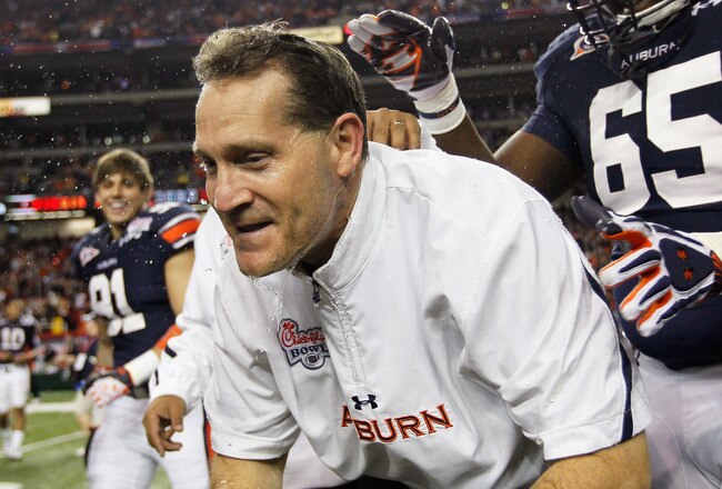 ATLANTA, GA - DECEMBER 31:  Head coach Gene Chizik of the Auburn Tigers is dunked after their 43-24 win over the Virginia Cavaliers during the 2011 Chick Fil-A Bowl at Georgia Dome on December 31, 2011 in Atlanta, Georgia.  (Photo by Kevin C. Cox/Getty Images)