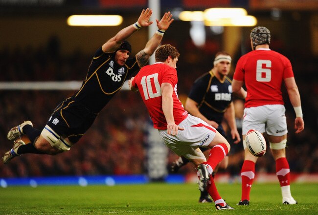 CARDIFF, WALES - FEBRUARY 12:  Rhys Priestland of Wales kicks the ball under pressure from Alasdair Strokosch of Scotland during the RBS Six Nations match between Wales and Scotland at the Millenium Stadium on February 12, 2012 in Cardiff, Wales.  (Photo by Mike Hewitt/Getty Images)