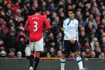 MANCHESTER, ENGLAND - FEBRUARY 11:  Luis Suarez of Liverpool looks at Patrice Evra of Manchester United during the Barclays Premier League match between Manchester United and Liverpool at Old Trafford on February 11, 2012 in Manchester, England.  (Photo by Shaun Botterill/Getty Images)