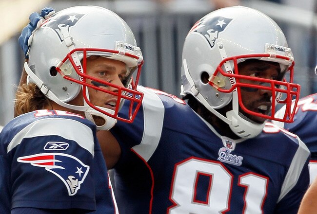 FOXBORO, MA - SEPTEMBER 26:  Tom Brady #12 of the New England Patriots celebrates with  Randy Moss #81 after Moss made a touchdown catch against the Buffalo Bills at Gillette Stadium on September 26, 2010 in Foxboro, Massachusetts. (Photo by Jim Rogash/Getty Images)