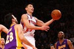NEW YORK, NY - FEBRUARY 10:  Jeremy Lin #17 of the New York Knicks drives for a shot attempt in the fourth quarter against Jason Kapono #28 and Kobe Bryant #24 of the Los Angeles Lakers at Madison Square Garden on February 10, 2012 in New York City.  NOTE TO USER: User expressly acknowledges and agrees that, by downloading and or using this photograph, User is consenting to the terms and conditions of the Getty Images License Agreement.  (Photo by Chris Chambers/Getty Images)