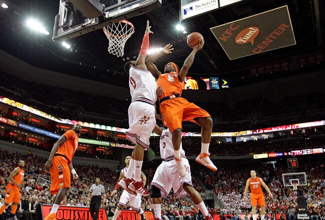 LOUISVILLE, KY - FEBRUARY 12:  George Goode #0 of the Louisville Cardinals defends the shot of C.J. Fair #5 of the Syracuse Orange during the Big East Conference game against  at the KFC Yum! Center on February 12, 2011 in Louisville, Kentucky.  (Photo by Andy Lyons/Getty Images)