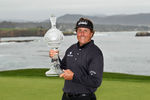 PEBBLE BEACH, CA - FEBRUARY 12:  Phil Mickelson celebrates with the tournament trophy after winning with an eight-under-par 64 during the AT&T Pebble Beach National Pro-Am at Pebble Beach Golf Links on February 12, 2012 in Pebble Beach, California.  (Photo by Ezra Shaw/Getty Images)
