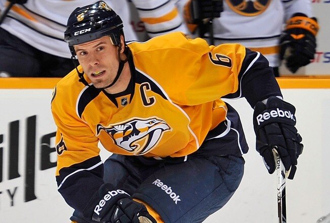 NASHVILLE, TN - DECEMBER 03: Shea Weber #6 of the Nashville Predators skates past a falling Thomas Vanek #26 of the Buffalo Sabres at the Bridgestone Arena on December 3, 2011 in Nashville, Tennessee.  (Photo by Frederick Breedon/Getty Images)
