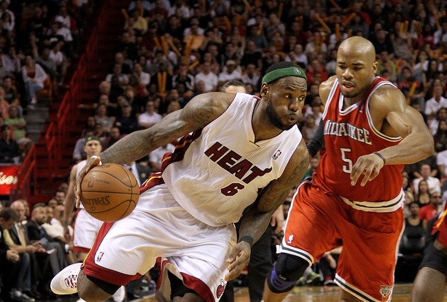 MIAMI, FL - APRIL 06:  Lebron James #6 of the Miami Heat is guarded by by Corey Maggette #5 of the Milwaukee Bucks during a game at American Airlines Arena on April 6, 2011 in Miami, Florida. NOTE TO USER: User expressly acknowledges and agrees that, by downloading and/or using this Photograph, User is consenting to the terms and conditions of the Getty Images License Agreement.  (Photo by Mike Ehrmann/Getty Images)