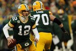 GREEN BAY, WI - JANUARY 15:  Aaron Rodgers #12 of the Green Bay Packers drops back against the New York Giants during their NFC Divisional playoff game at Lambeau Field on January 15, 2012 in Green Bay, Wisconsin.  (Photo by Jonathan Daniel/Getty Images)