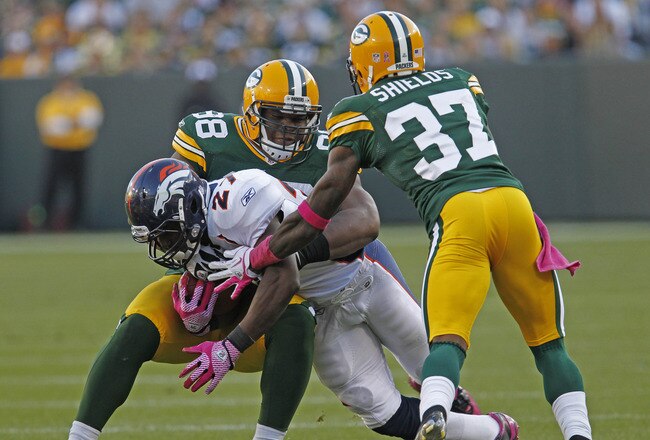 GREEN BAY, WI - OCTOBER 2: Knowshon Moreno #27 of the Denver Broncos gets hit by C.J. Wilson #98 and Sam Shields #37 of the Green Bay Packers at Lambeau Field on October 2, 2011 in Green Bay, Wisconsin.  (Photo by Matt Ludtke /Getty Images)