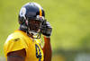LATROBE, PA - JULY 29:  James Harrison #92 of the Pittsburgh Steelers snaps in his chin guard during training camp on July 29, 2011 at St Vincent College in Latrobe, Pennsylvania.  (Photo by Jared Wickerham/Getty Images)