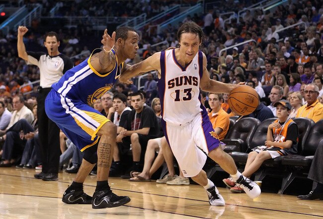 PHOENIX - OCTOBER 19:  Steve Nash #13 of the Phoenix Suns drives the ball past Monta Ellis #8 of the Golden State Warriors during the preseason NBA game at US Airways Center on October 19, 2010 in Phoenix, Arizona. NOTE TO USER: User expressly acknowledges and agrees that, by downloading and or using this photograph, User is consenting to the terms and conditions of the Getty Images License Agreement.  (Photo by Christian Petersen/Getty Images)