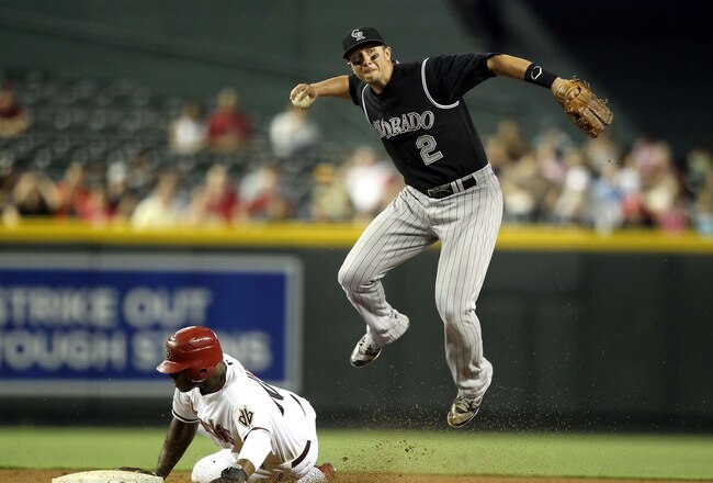 PHOENIX, AZ - AUGUST 29:  Infielder Troy Tulowitzki #2 of the Colorado Rockies throws over the sliding Justin Upton #10 of the Arizona Diamondbacks to complete a double play during the third inning of the Major League Baseball game at Chase Field on August 29, 2011 in Phoenix, Arizona.  (Photo by Christian Petersen/Getty Images)