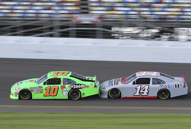 DAYTONA BEACH, FL - JANUARY 13:  Danica Patrick, driver of the #10 GoDaddy.com Chevrolet, drafts with Tony Stewart, driver of the #14 Office Deopt Chevrolet, during Daytona Preseason Thunder at Daytona International Speedway on January 13, 2012 in Daytona Beach, Florida.  (Photo by Jerry Markland/Getty Images for NASCAR)