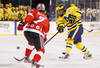 CLEVELAND, OH - JANUARY 15: Kevin Lynch #14 of the Michigan Wolverines takes a shot past Al McLean #7 of the Ohio State Buckeys during the Frozen Diamond Faceoff at Progressive Field on January 15, 2012 in Cleveland, Ohio. (Photo by Gregory Shamus/Getty Images)