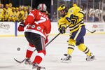 CLEVELAND, OH - JANUARY 15: Kevin Lynch #14 of the Michigan Wolverines takes a shot past Al McLean #7 of the Ohio State Buckeys during the Frozen Diamond Faceoff at Progressive Field on January 15, 2012 in Cleveland, Ohio. (Photo by Gregory Shamus/Getty Images)