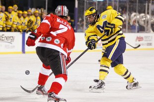 CLEVELAND, OH - JANUARY 15: Kevin Lynch #14 of the Michigan Wolverines takes a shot past Al McLean #7 of the Ohio State Buckeys during the Frozen Diamond Faceoff at Progressive Field on January 15, 2012 in Cleveland, Ohio. (Photo by Gregory Shamus/Getty Images)