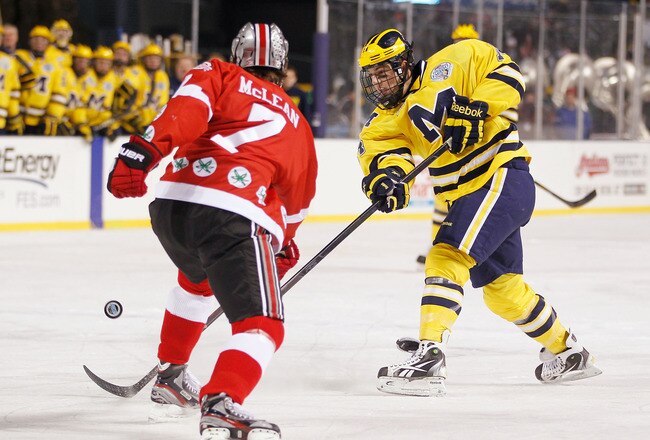 CLEVELAND, OH - JANUARY 15: Kevin Lynch #14 of the Michigan Wolverines takes a shot past Al McLean #7 of the Ohio State Buckeys during the Frozen Diamond Faceoff at Progressive Field on January 15, 2012 in Cleveland, Ohio. (Photo by Gregory Shamus/Getty Images)