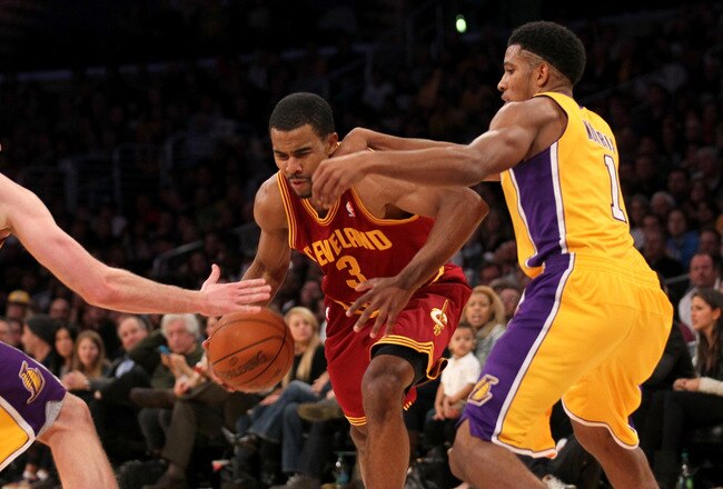 LOS ANGELES, CA - JANUARY 13: Ramon Sessions #3 of the Cleveland Cavaliers drives between Darius Morris #1 and Troy Murphy #14 of the Los Angeles Lakers at Staples Center on January 13, 2012 in Los Angeles, California.  The Lakers won 97-92. NOTE TO USER: User expressly acknowledges and agrees that, by downloading and or using this photograph, User is consenting to the terms and conditions of the Getty Images License Agreement.  (Photo by Stephen Dunn/Getty Images)