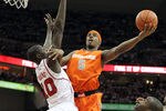 LOUISVILLE, KY - FEBRUARY 13:  C.J. Fair #5 of the Syracuse Orange shoots the ball while defended by Gorgui Dieng #10 of the Louisville Cardinals during the Big East Conference game at KFC YUM! Center on February 13, 2012 in Louisville, Kentucky.  (Photo by Andy Lyons/Getty Images)