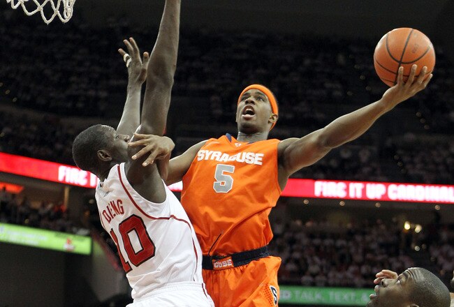 LOUISVILLE, KY - FEBRUARY 13:  C.J. Fair #5 of the Syracuse Orange shoots the ball while defended by Gorgui Dieng #10 of the Louisville Cardinals during the Big East Conference game at KFC YUM! Center on February 13, 2012 in Louisville, Kentucky.  (Photo by Andy Lyons/Getty Images)