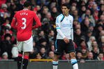 MANCHESTER, ENGLAND - FEBRUARY 11:  Luis Suarez of Liverpool looks at Patrice Evra of Manchester United during the Barclays Premier League match between Manchester United and Liverpool at Old Trafford on February 11, 2012 in Manchester, England.  (Photo by Shaun Botterill/Getty Images)