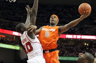 LOUISVILLE, KY - FEBRUARY 13:  C.J. Fair #5 of the Syracuse Orange shoots the ball while defended by Gorgui Dieng #10 of the Louisville Cardinals during the Big East Conference game at KFC YUM! Center on February 13, 2012 in Louisville, Kentucky.  (Photo by Andy Lyons/Getty Images)