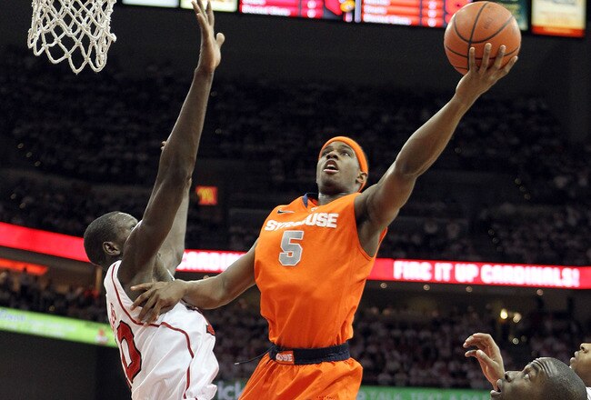 LOUISVILLE, KY - FEBRUARY 13: C.J. Fair #5 of the Syracuse Orange shoots the ball while defended by Gorgui Dieng #10 of the Louisville Cardinals during the Big East Conference game at KFC YUM! Center on February 13, 2012 in Louisville, Kentucky.  (Photo by Andy Lyons/Getty Images)