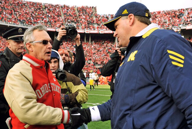 COLUMBUS, OH - NOVEMBER 27:  Head Coach Jim Tressel of the Ohio State Buckeyes shakes hands with Head Coach Rich Rodriguez after the Buckeyes defeated the Wolverines 37-7 at Ohio Stadium on November 27, 2010 in Columbus, Ohio.  (Photo by Jamie Sabau/Getty Images)