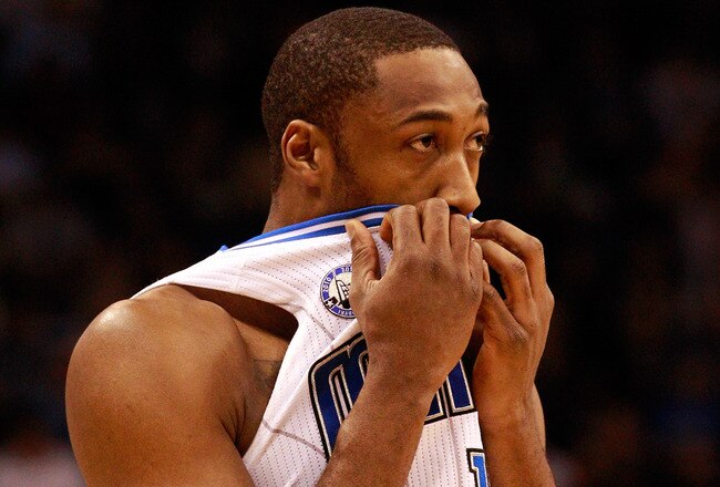 ORLANDO, FL - FEBRUARY 13:  Gilbert Arenas #1 of the Orlando Magic covers his mouth during the game against the Los Angeles Lakers at Amway Arena on February 13, 2011 in Orlando, Florida.  NOTE TO USER: User expressly acknowledges and agrees that, by downloading and or using this Photograph, user is consenting to the terms and conditions of the Getty Images License Agreement.  (Photo by Sam Greenwood/Getty Images)