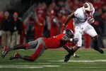 COLUMBUS, OH - OCTOBER 29:  C.J. Barnett #4 of the Ohio State Buckeyes tackles Nick Toon #1 of the Wisconsin Badgers during the third quarter on October 29, 2011 at Ohio Stadium in Columbus, Ohio. Ohio State defeated Wisconsin 33-29. (Photo by Kirk Irwin/Getty Images)