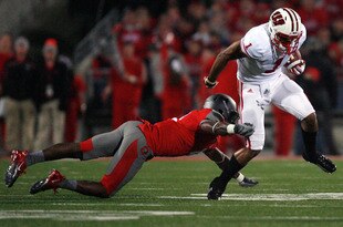 COLUMBUS, OH - OCTOBER 29:  C.J. Barnett #4 of the Ohio State Buckeyes tackles Nick Toon #1 of the Wisconsin Badgers during the third quarter on October 29, 2011 at Ohio Stadium in Columbus, Ohio. Ohio State defeated Wisconsin 33-29. (Photo by Kirk Irwin/Getty Images)