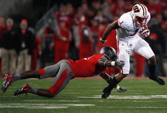 COLUMBUS, OH - OCTOBER 29:  C.J. Barnett #4 of the Ohio State Buckeyes tackles Nick Toon #1 of the Wisconsin Badgers during the third quarter on October 29, 2011 at Ohio Stadium in Columbus, Ohio. Ohio State defeated Wisconsin 33-29. (Photo by Kirk Irwin/Getty Images)